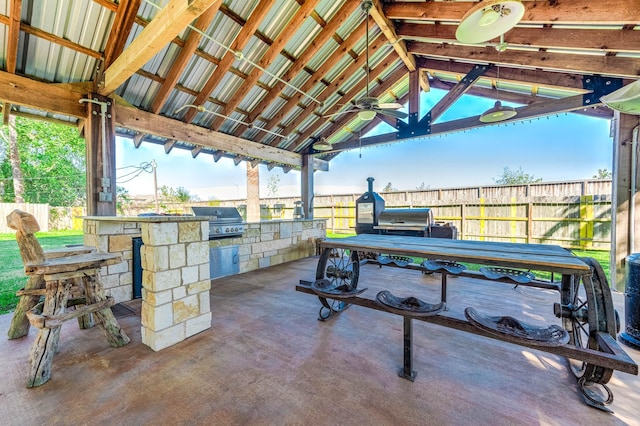 view of patio with a gazebo, ceiling fan, exterior kitchen, and grilling area