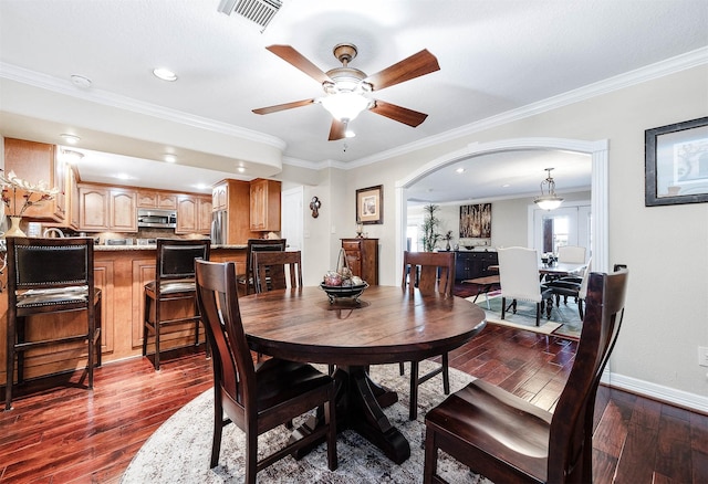 dining area with hardwood / wood-style floors, ceiling fan, and ornamental molding