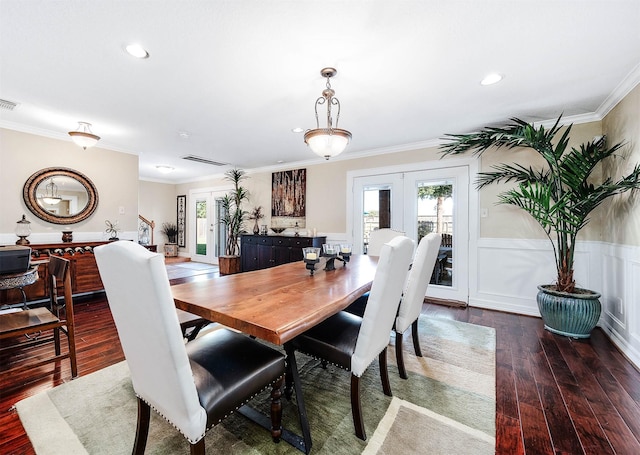 dining space with french doors, dark hardwood / wood-style floors, and ornamental molding