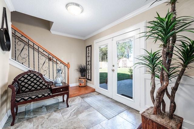 doorway with crown molding and french doors