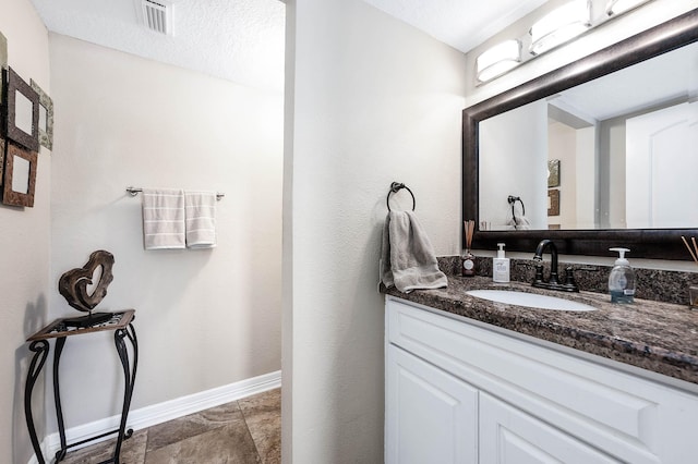 bathroom with vanity and a textured ceiling