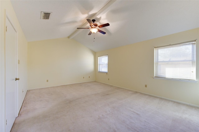 carpeted empty room featuring lofted ceiling with beams and ceiling fan