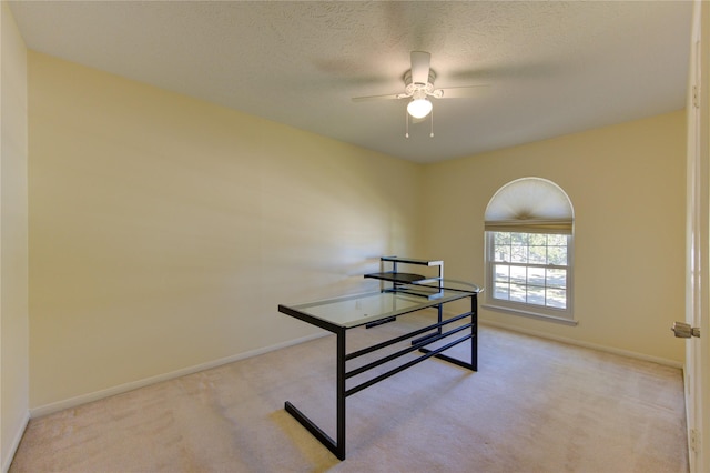 interior space with ceiling fan and a textured ceiling