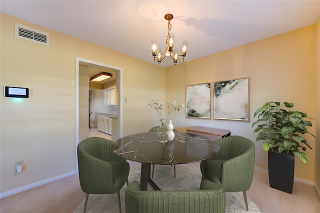 carpeted dining room with a notable chandelier