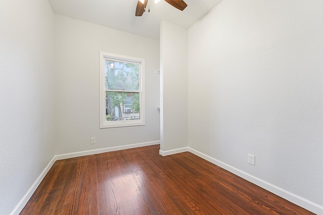 spare room featuring dark hardwood / wood-style flooring and ceiling fan