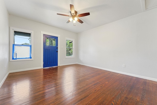 entryway with dark hardwood / wood-style flooring and ceiling fan