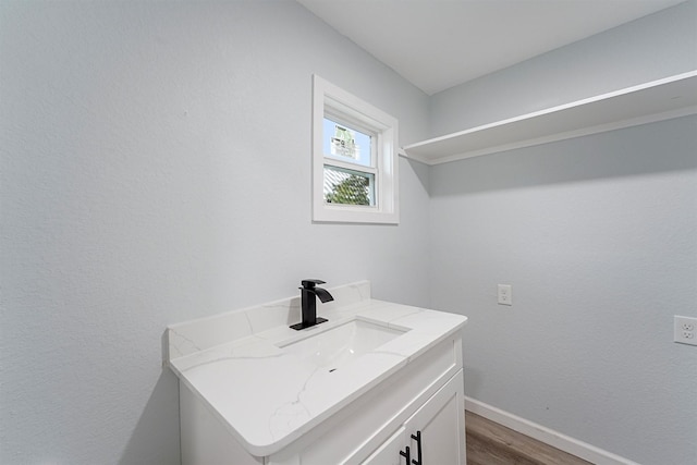 bathroom with vanity and hardwood / wood-style flooring