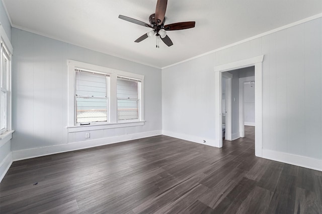 spare room featuring dark hardwood / wood-style floors, ceiling fan, and crown molding