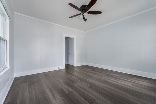 empty room featuring dark hardwood / wood-style floors, ceiling fan, and ornamental molding