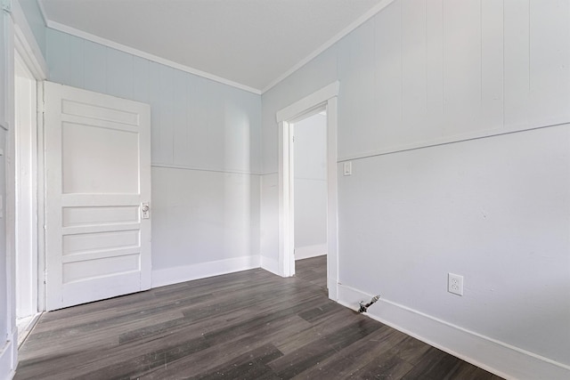 spare room with dark hardwood / wood-style floors and ornamental molding