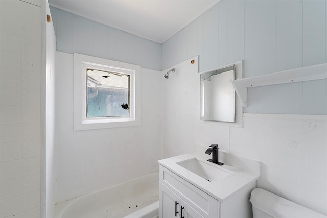 bathroom featuring a shower, vanity, and toilet