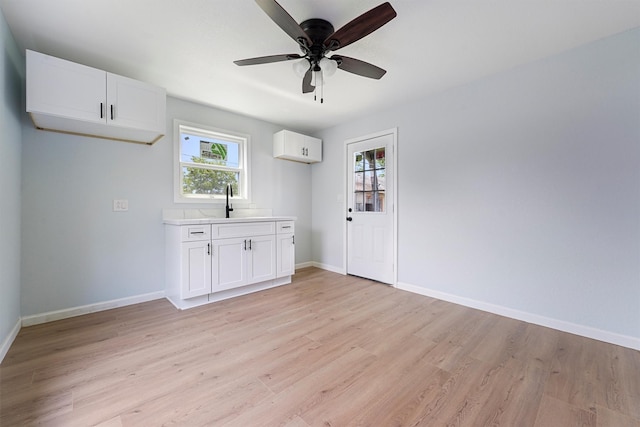 interior space featuring a healthy amount of sunlight, light wood-type flooring, and sink