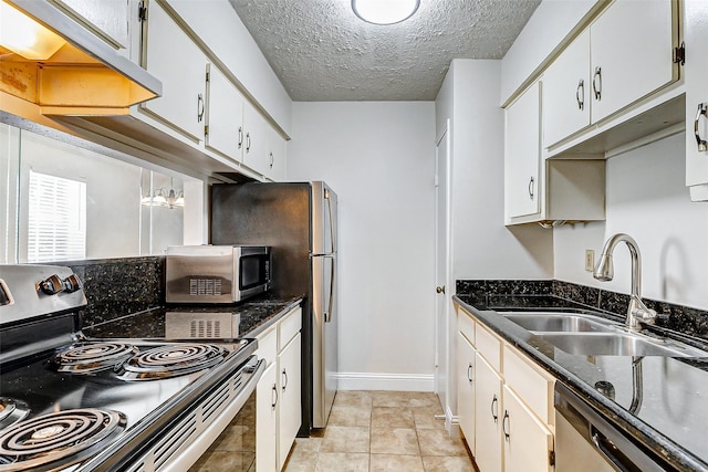 kitchen featuring white cabinets, a textured ceiling, stainless steel appliances, and sink