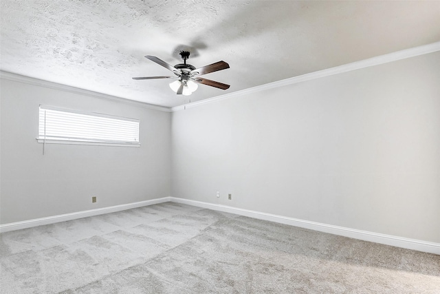 spare room featuring a textured ceiling, ceiling fan, light colored carpet, and crown molding