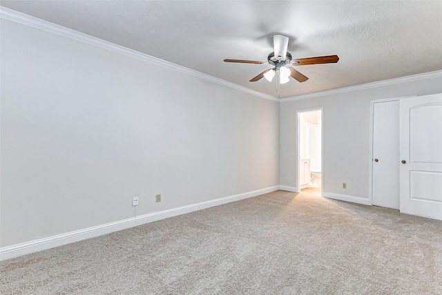 unfurnished bedroom featuring connected bathroom, ceiling fan, crown molding, a textured ceiling, and light carpet