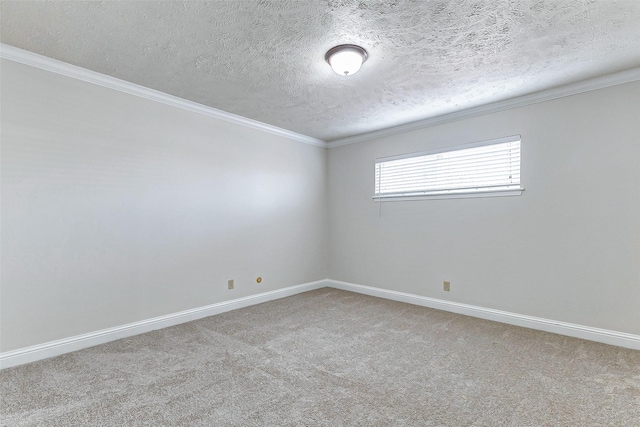 spare room with carpet flooring, a textured ceiling, and ornamental molding