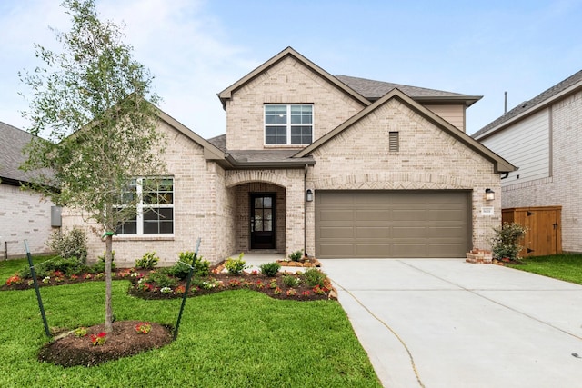 8618 Sun Coral Dr, Cypress, TX 77433 - view of front facade with a shingled roof, a front lawn, brick siding, and driveway