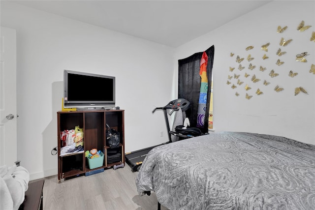 bedroom with hardwood / wood-style flooring