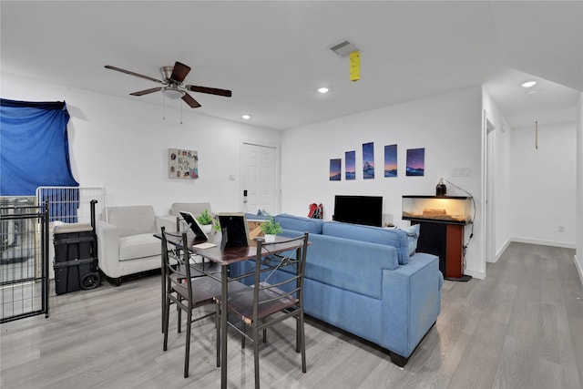 living room featuring ceiling fan and light hardwood / wood-style floors