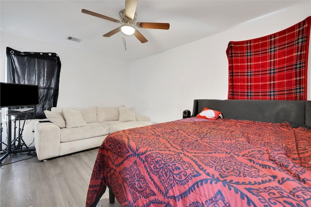 bedroom with hardwood / wood-style floors and ceiling fan