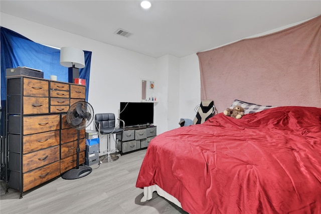 bedroom with hardwood / wood-style floors