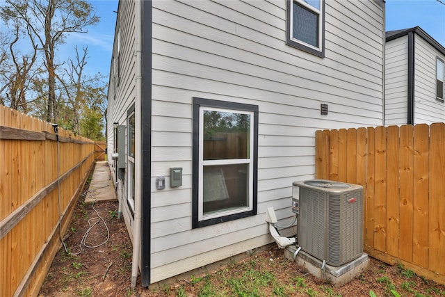 view of side of property featuring central AC