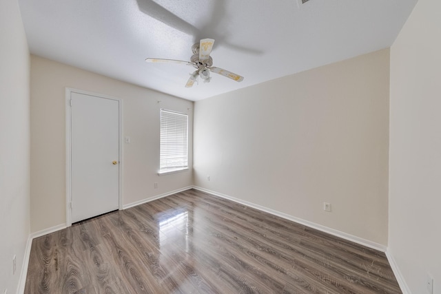 empty room featuring wood-type flooring and ceiling fan