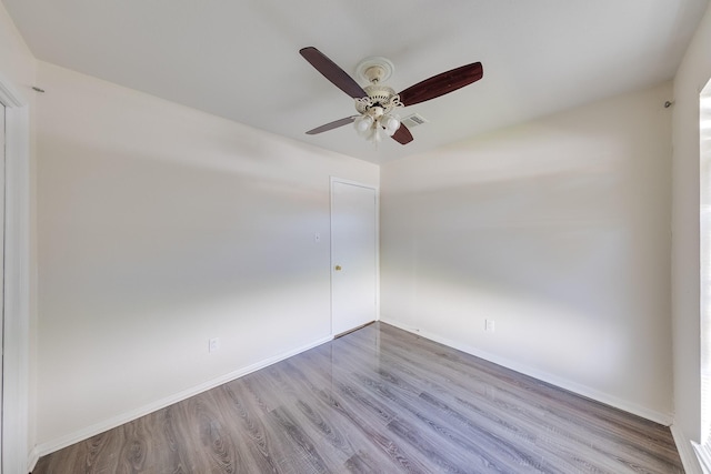 spare room with hardwood / wood-style flooring and ceiling fan