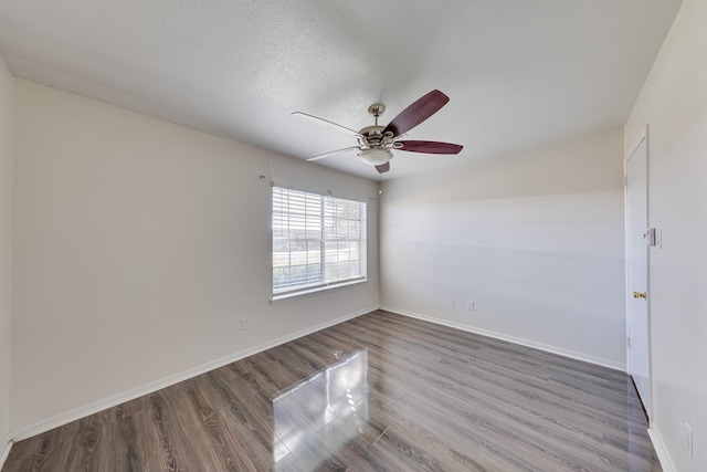 spare room with hardwood / wood-style flooring, ceiling fan, and a textured ceiling