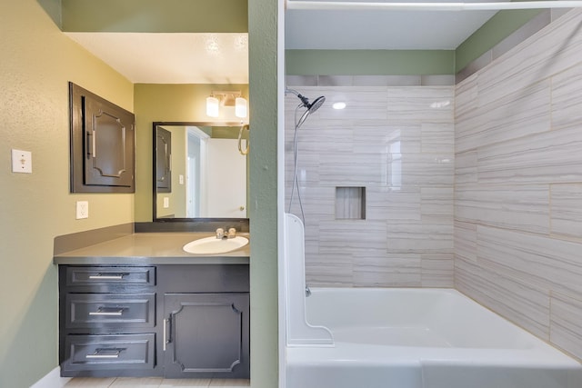 bathroom featuring vanity and tiled shower / bath