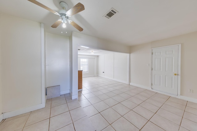 tiled empty room with ceiling fan