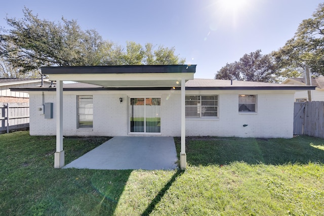 rear view of property with a lawn and a patio area