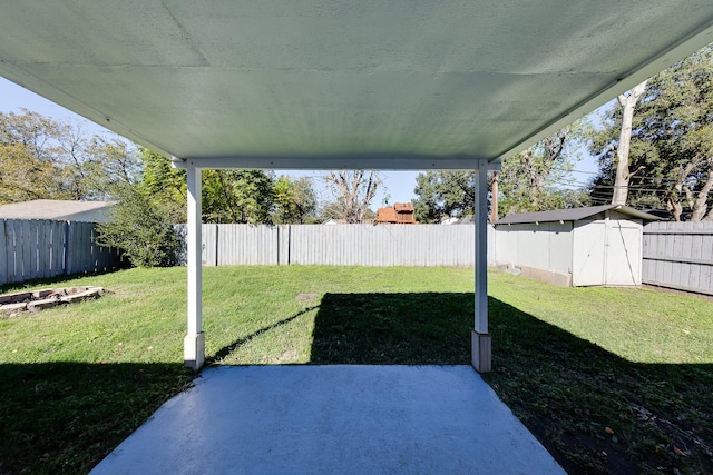 view of yard featuring a patio and a shed