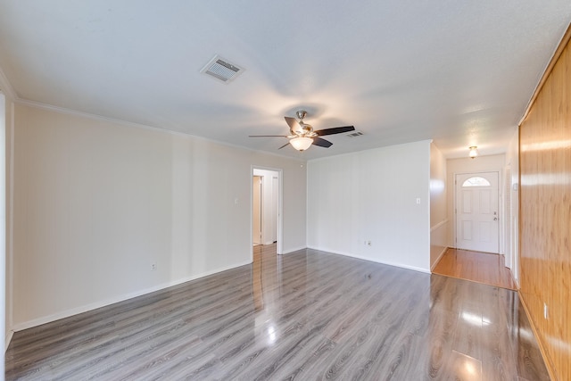 spare room featuring ceiling fan, light hardwood / wood-style floors, and ornamental molding