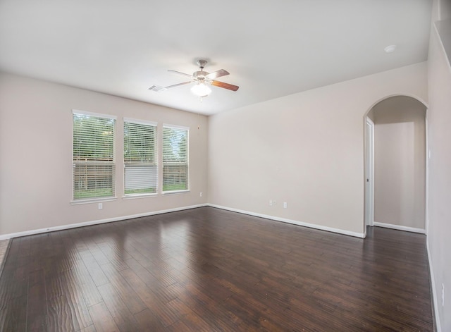 spare room with ceiling fan and dark wood-type flooring