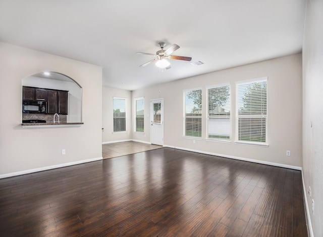 unfurnished living room featuring hardwood / wood-style floors and ceiling fan