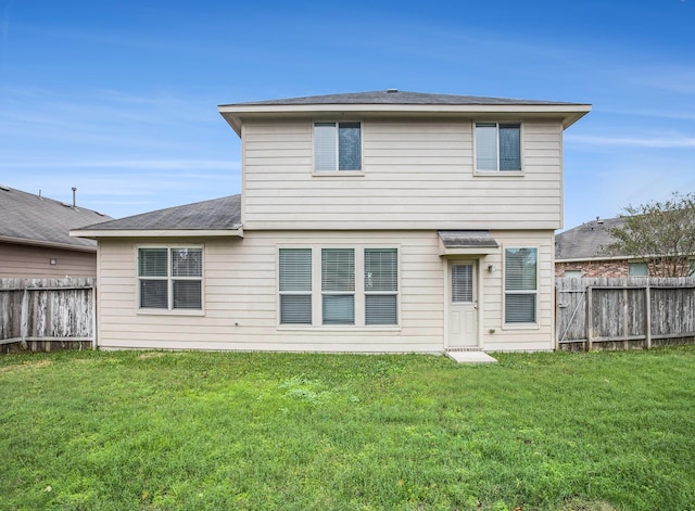 back of house featuring a lawn