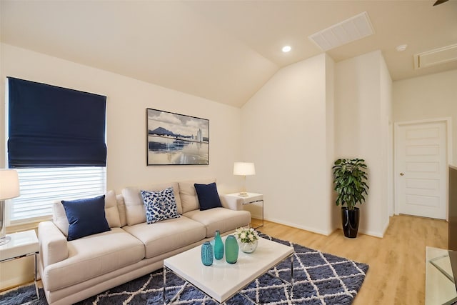 living room featuring hardwood / wood-style flooring and vaulted ceiling