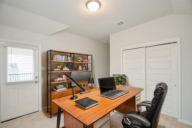 carpeted office space with vaulted ceiling