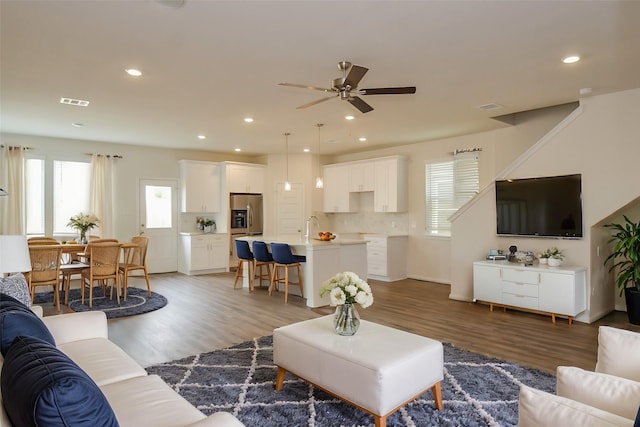 14983 Eagle Feather Dr, Houston, TX 77090 - living room with a wealth of natural light, a ceiling fan, visible vents, and light wood finished floors
