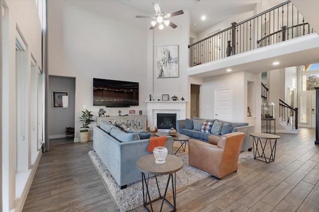 living room featuring hardwood / wood-style floors and a towering ceiling