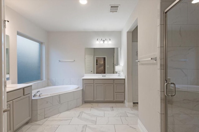 bathroom featuring vanity and shower with separate bathtub