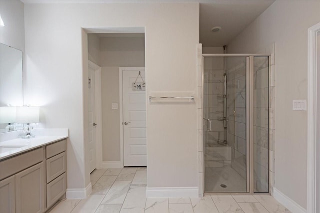 bathroom with a shower with door and vanity