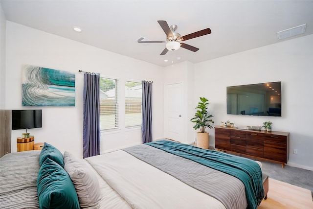 bedroom featuring ceiling fan and light colored carpet