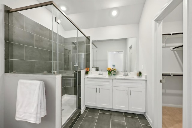 bathroom with tile patterned floors, vanity, and an enclosed shower