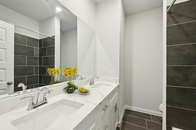 bathroom featuring tile patterned flooring, vanity, and toilet