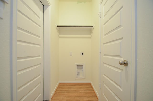 washroom featuring laundry area, baseboards, light wood finished floors, and electric dryer hookup