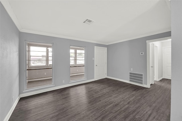 spare room with dark hardwood / wood-style flooring and crown molding