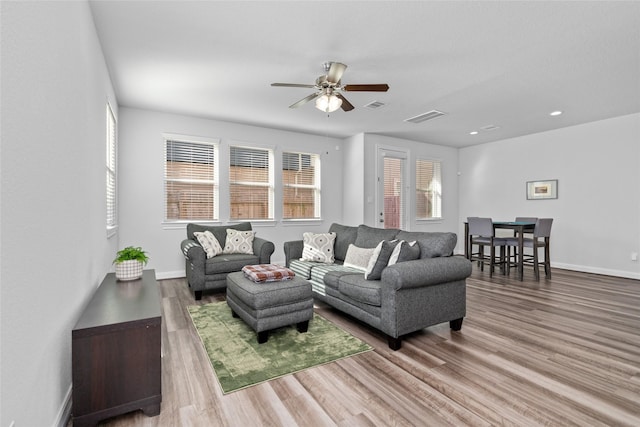 living room with hardwood / wood-style floors and ceiling fan