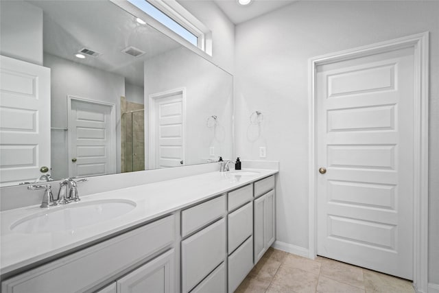 bathroom featuring vanity, tile patterned floors, and walk in shower